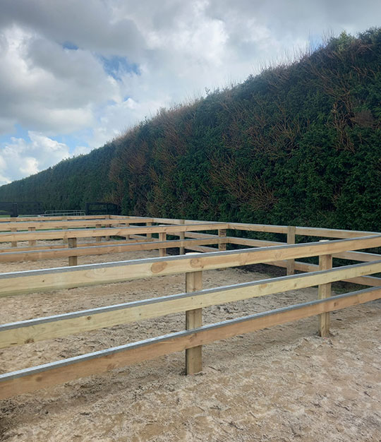 Post and rail fence with metal capping